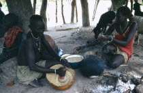 Dinka woman making mung bean and groundnut paste.