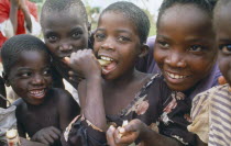 Young children eating sugar cane