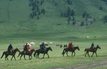 Kazakh people on horseback on their way to the horse races