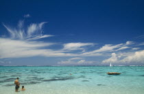 Moorea.  Beach and tourist sunbathers and swimmers.