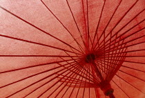 Inside view of red painted umbrella in village outside Chiang Mai which specialises in their production.