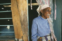 Kisongo Masai market outside Arusha.  Portrait of Pauline  owner of small teahouse  laughing in doorway.