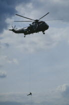 Soldier absailing from Sea King helicopter