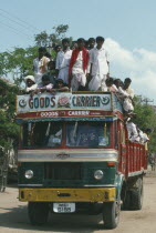 Goods Carrier truck crowded with passengers.