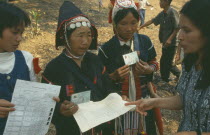 Akha tribeswomen being issued with ID cards enabling them to work legally to avoid prostitution.