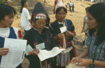 Akha tribeswomen being issued with ID cards enabling them to work legally to avoid prostitution.