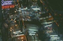 Patpong Road. Red light and commercial district. View over stalls illuminated at night.