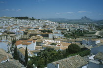 View over roofs and streets with Torcal Plateau beyond. Andalusia