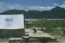 Indonesia, Tsunami, Aceh Province, Displaced peoples camp after December 2004. UNHCR tent in the foreground.