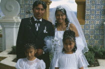 Wedding in El Monticulo. Bride  Groom and two young bridesmaids.