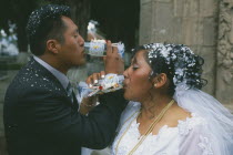 Wedding in El Monticulo. Bride and Groom interlocking arms and drinking.