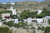 Ano Mana village on a mountain side with trees.