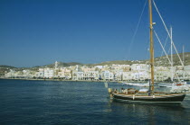 Ermoupolis. Sailing boats in the port with view of the seaside town.