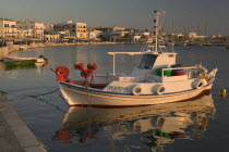 HoraView of a boat docked in the port with buildings behind.  MediterraneanTravelTourismHolidaysFishing boats