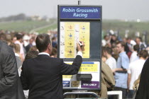 Betting stall at Brighton Race Course with man writing in the odds with a markerTic Tac Man