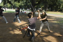 Harajuku. Yoyogi Park on Saturday afternoon  Miyuki Wada aged 31 and Takaki Hagi aged 20  practice sword fighting for Ichigaya Tanabata Festival