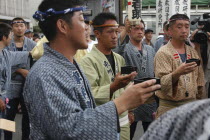 Gion Matsuri with men in  traditional Edo-era costumes toasting each other with sake