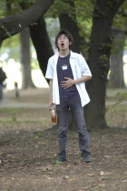 Harajuku. Masafumi Suzuki  20 year old student at Japan Narration Technical School  does vocal exercises in Yoyogi Park on a Saturday afternoon