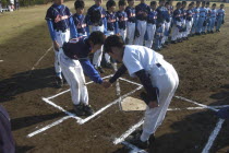 Team captain  12 year old 6th grader  shakes hands with opposing captain from Nakamura village at home plate of Toujou Shonen Yakyu baseball Club