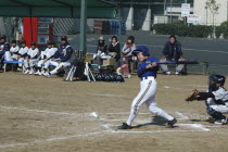 Captain Toshiki Hagiwara  12 year old 6th grader   watches the ball go for Toujou Shonen Yakyu Club  little league baseball