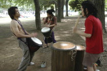 Harajuku. Yoyogi Park. Hiroaki Komura  and his brother Kenichi  with their friend Tomokazu Nagashima  playing African drums on a Saturday afternoon