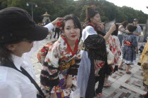 Harajuku. A member of the Kyoto Rokumeikan troupe has her hair adjusted during a break from dancing at the entrance of Yoyogi Park dressed in half kimono costumes on Saturday afternoon