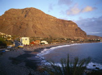 Valle Gran Rey.  Crowds on black volcanic sand beach at sunset.