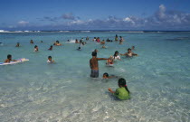 Atiu.  Girls swimming in the harbour.