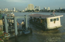 Chao Phrya River ferry boat with Silkom city buildings behind.