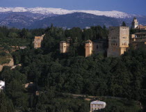 Alhambra Palace walls and towers seen from Mirador San Nicolas with the snow covered Sierra Nevada beyondAndalusia Andalucia