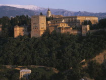 Alhambra Palace seen from Mirador San Nicolas in evening light with Palacio de Carlos V on the right Andalusia