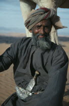 Man wearing a khanjar  a traditional curved dagger attached to his belt.khanja