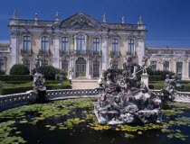 Palacio Nacional de Queluz facade with pond and central statue in the foreground.