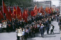 Marching crowds waving red banners and posters of Mao during the 1967 Cultural Revolution