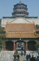 Chinese visitors on steps to gateway of tombs.Peking Beijing