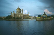 Omar Ali Saifuddin Mosque and boatlike jetty next to lagoon.