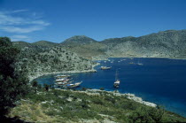 View over Loryma Bay with moored boats surrounded by hilly landscape