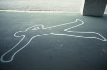 Painted outline of murder victim on sidewalk pavement