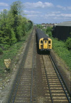 Railway tracks with approaching train.