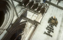 Royal Courts of Justice. View looking up at the building with the crest displayed on the wall.