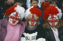 Fans with faces painted with the George Cross