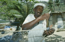 Fisherman mending nets on the beach.