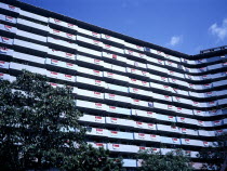 Singapore, Architecture, new housing development of modern multi-storey flats with flag of singapore hanging from every balcony on national day.