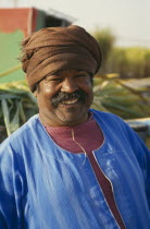 Smiling man wearing brown turban