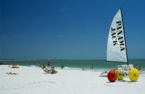 Hobbie cats and pedalos on beach.