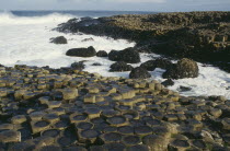 Giants Causeway. View over the naturally formed polygonal basalt columns and wash of sea