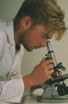 Technichian looking through a microscope