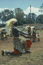 All male traditionally adorned Tutsi intore dancers characterised by coordinated drilling dances reflecting the Tutsi warrior tradition Watutsi