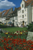 Houses and colourful flowerbeds on Skunu Street. Colorful