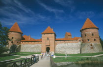 Visitors on bridge to entrance of Trakai Castle.